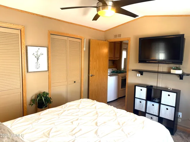 a bedroom with a bed and a flat screen tv