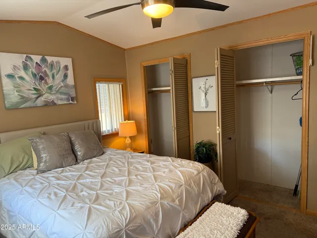 a bedroom with a bed and a painting on the wall