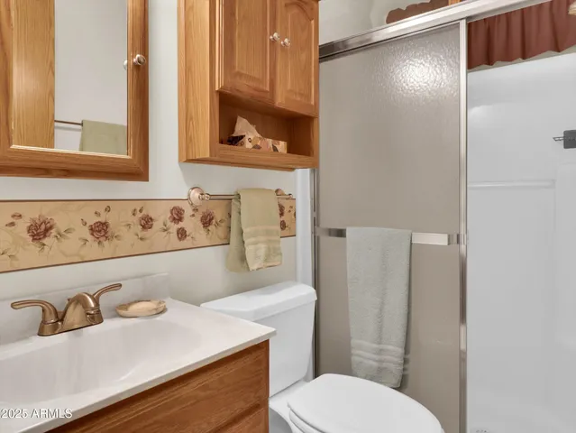 a bathroom with a sink toilet and mirror