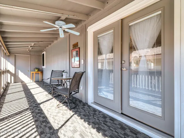 a workspace with wooden floor and a view of bedroom