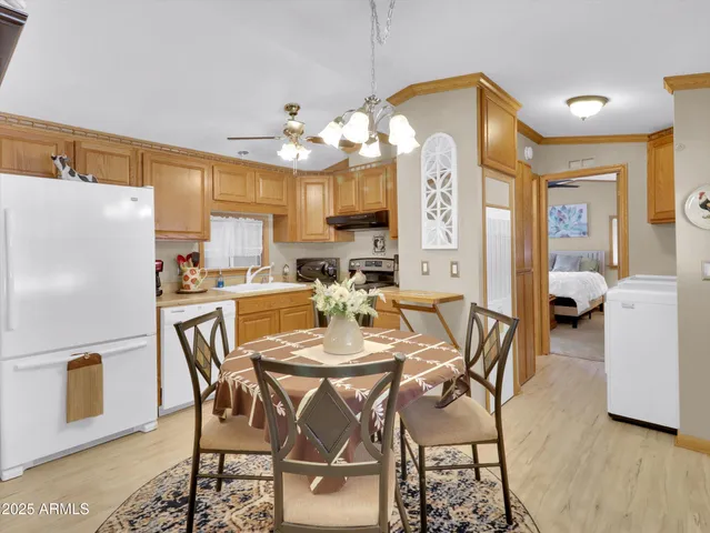 a view of a dining room with furniture and a chandelier