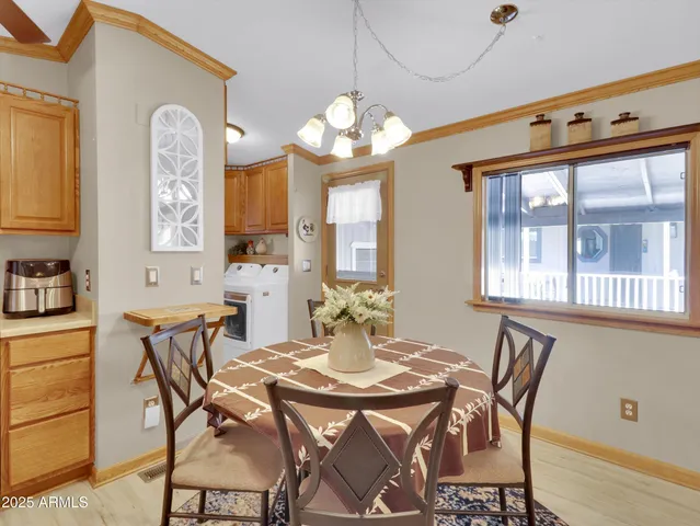 a view of a dining room with furniture and chandelier