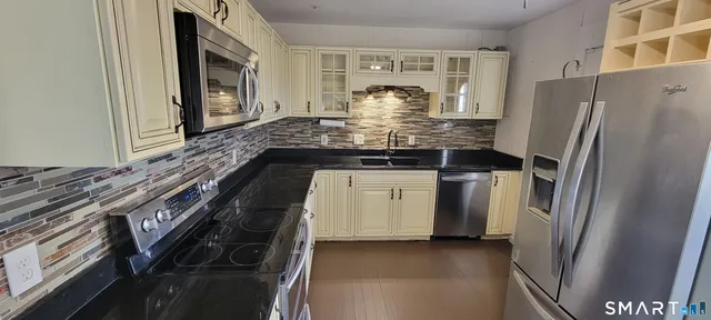 a kitchen with a refrigerator and a stove