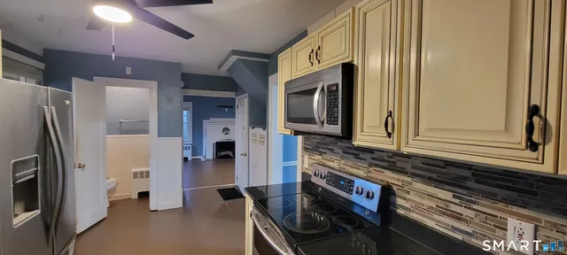 a kitchen with stainless steel appliances granite countertop a refrigerator and a stove