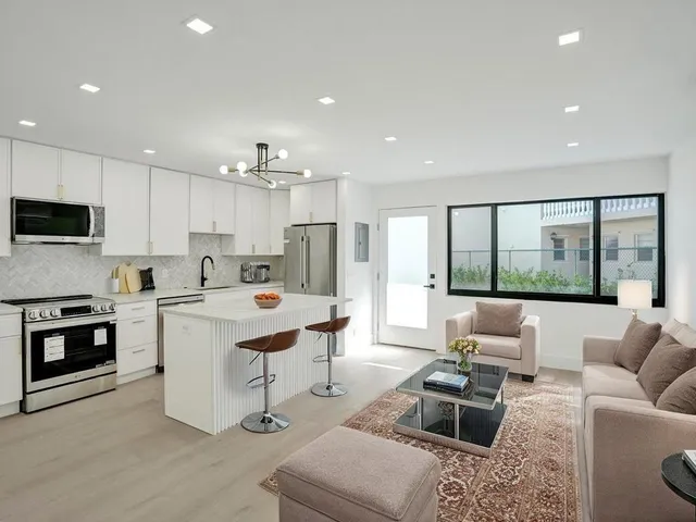 a bedroom with a bed and painting on the wall