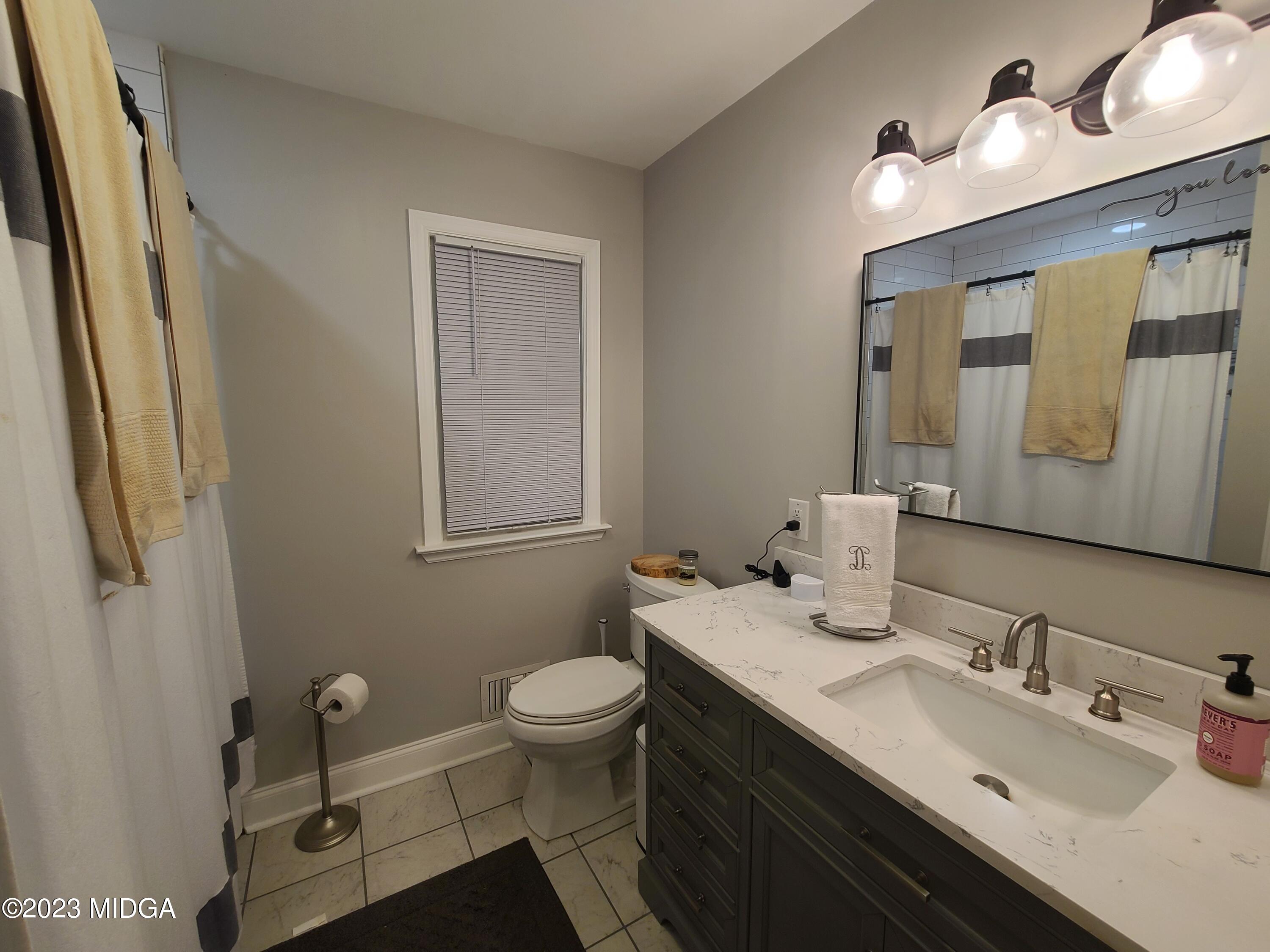 2638 Riverview Road Macon, GA 31204 - Photo 11 of 24 a bathroom with a sink and a mirror