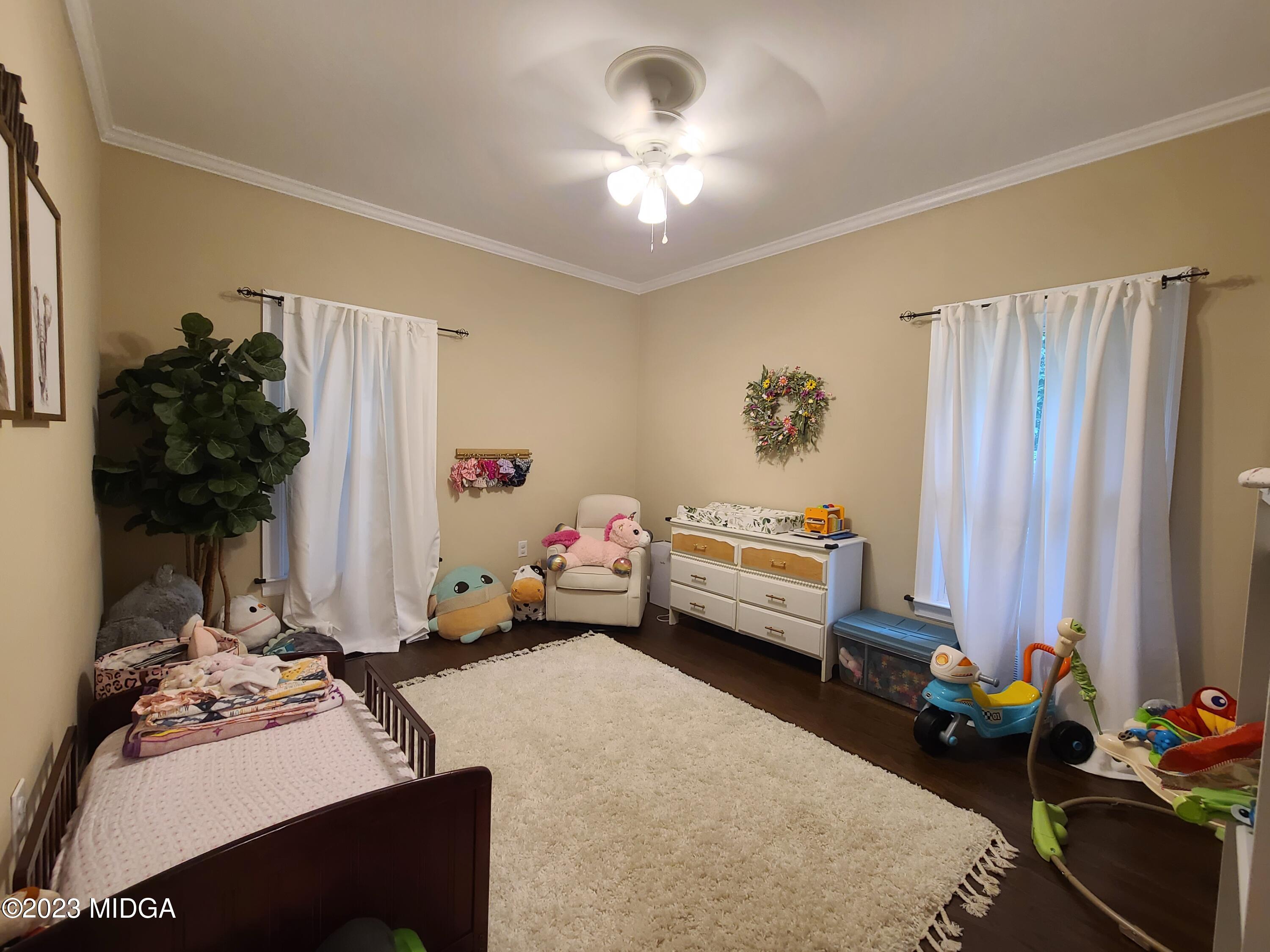 2638 Riverview Road Macon, GA 31204 - Photo 13 of 24 a bedroom with furniture a chandelier and a window