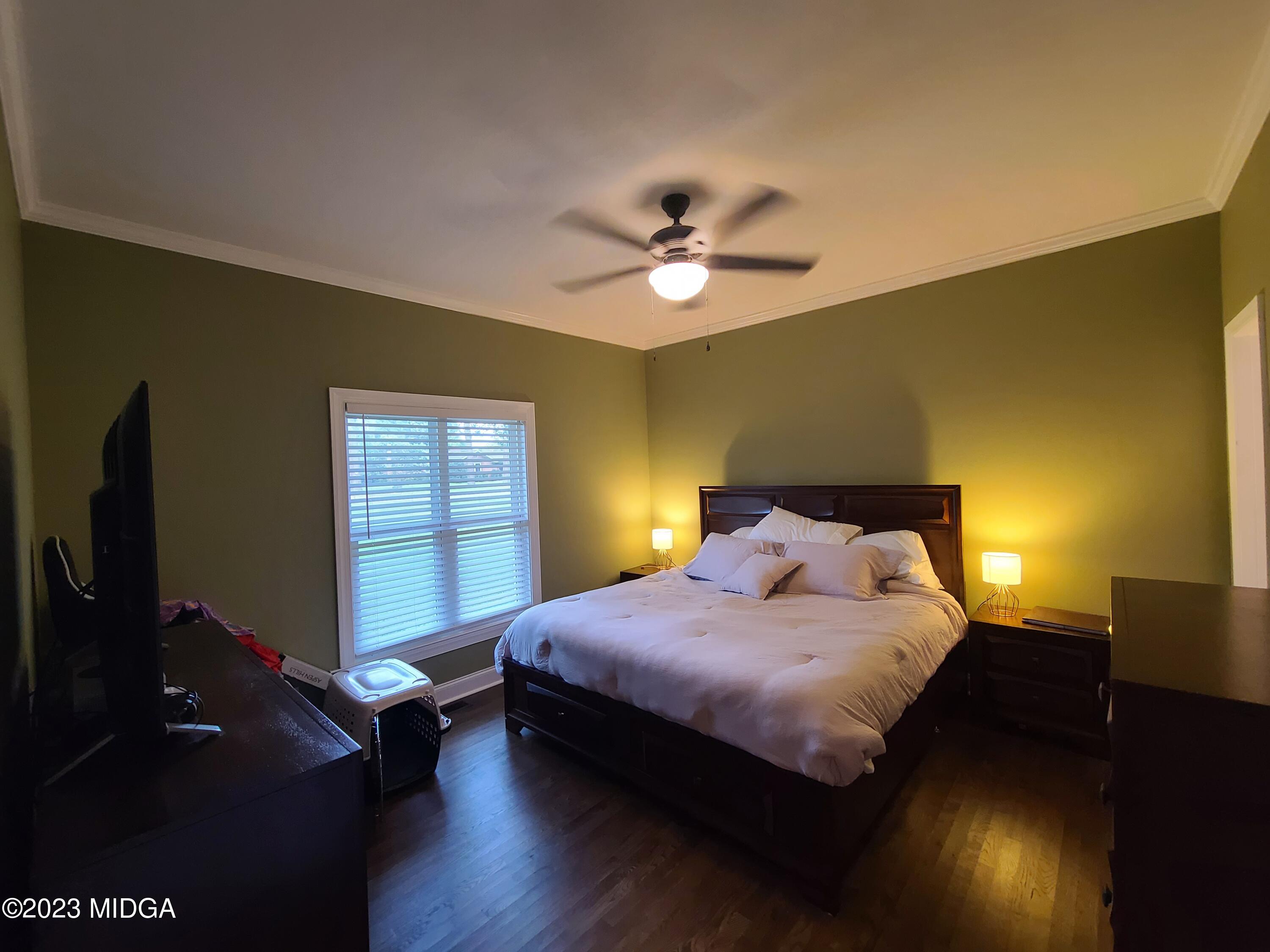 2638 Riverview Road Macon, GA 31204 - Photo 14 of 24 a bedroom with a bed and a flat screen tv