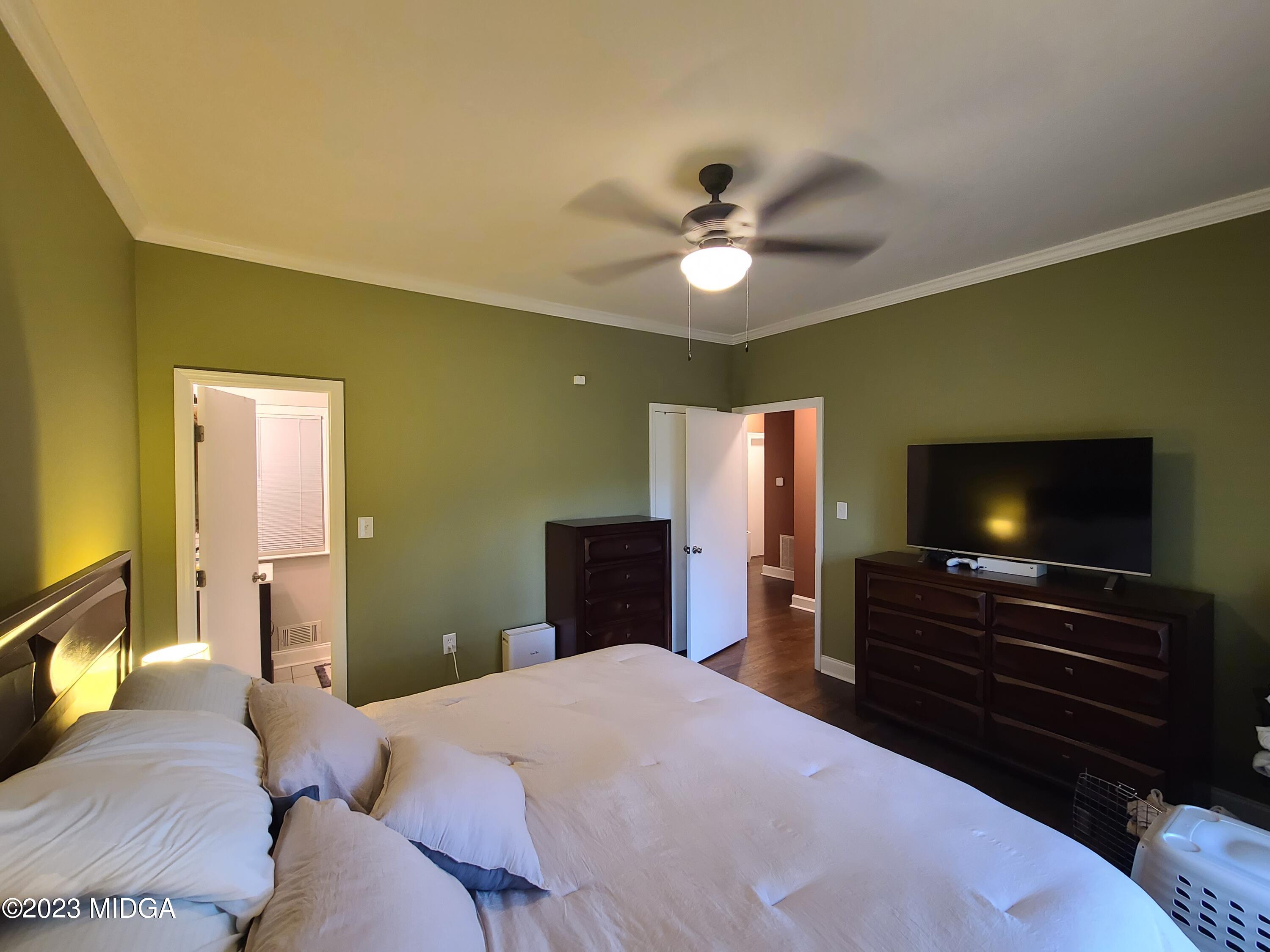 2638 Riverview Road Macon, GA 31204 - Photo 15 of 24 a bedroom with a bed and a flat screen tv