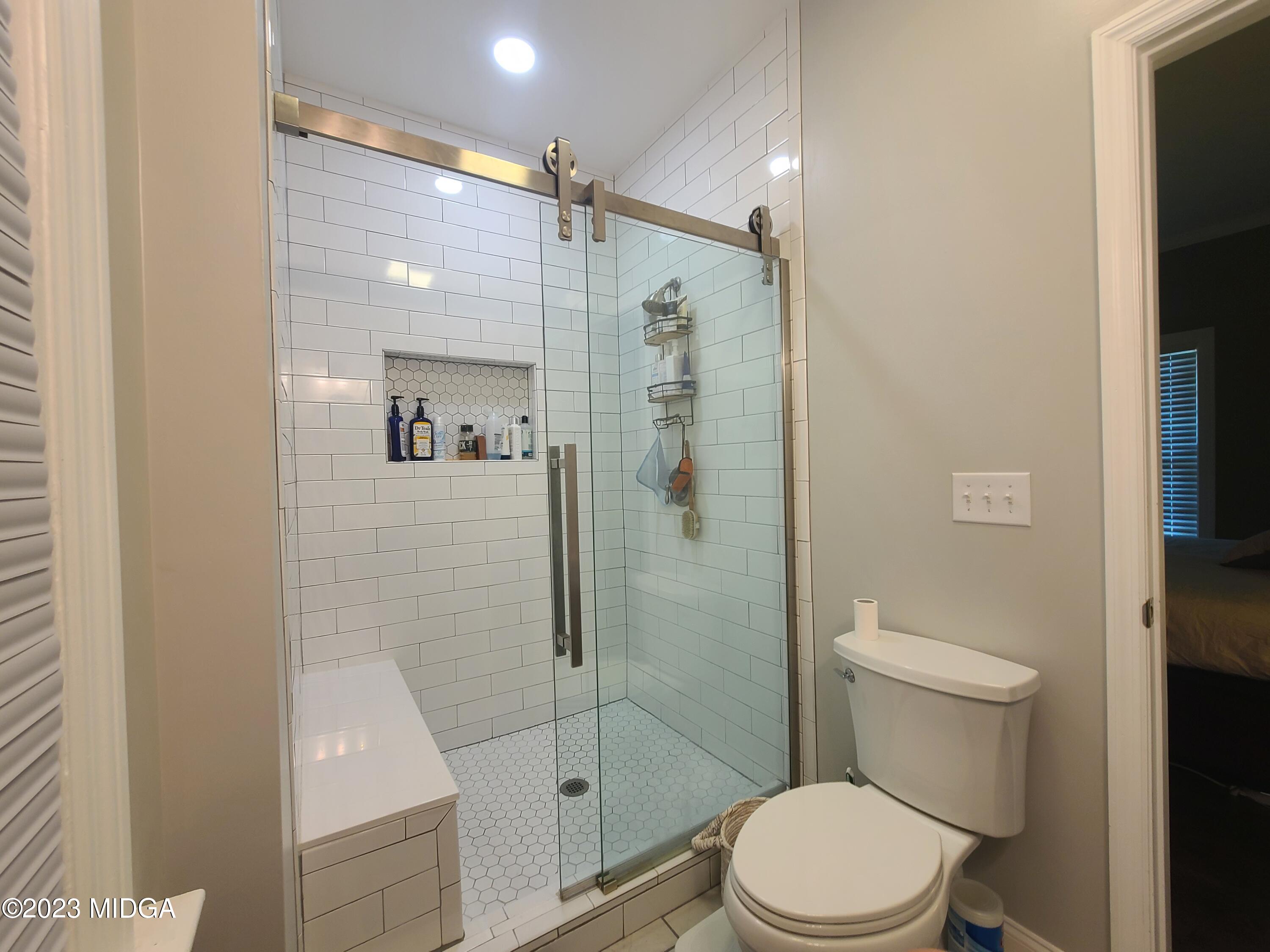 2638 Riverview Road Macon, GA 31204 - Photo 16 of 24 a bathroom with a shower a toilet and sink