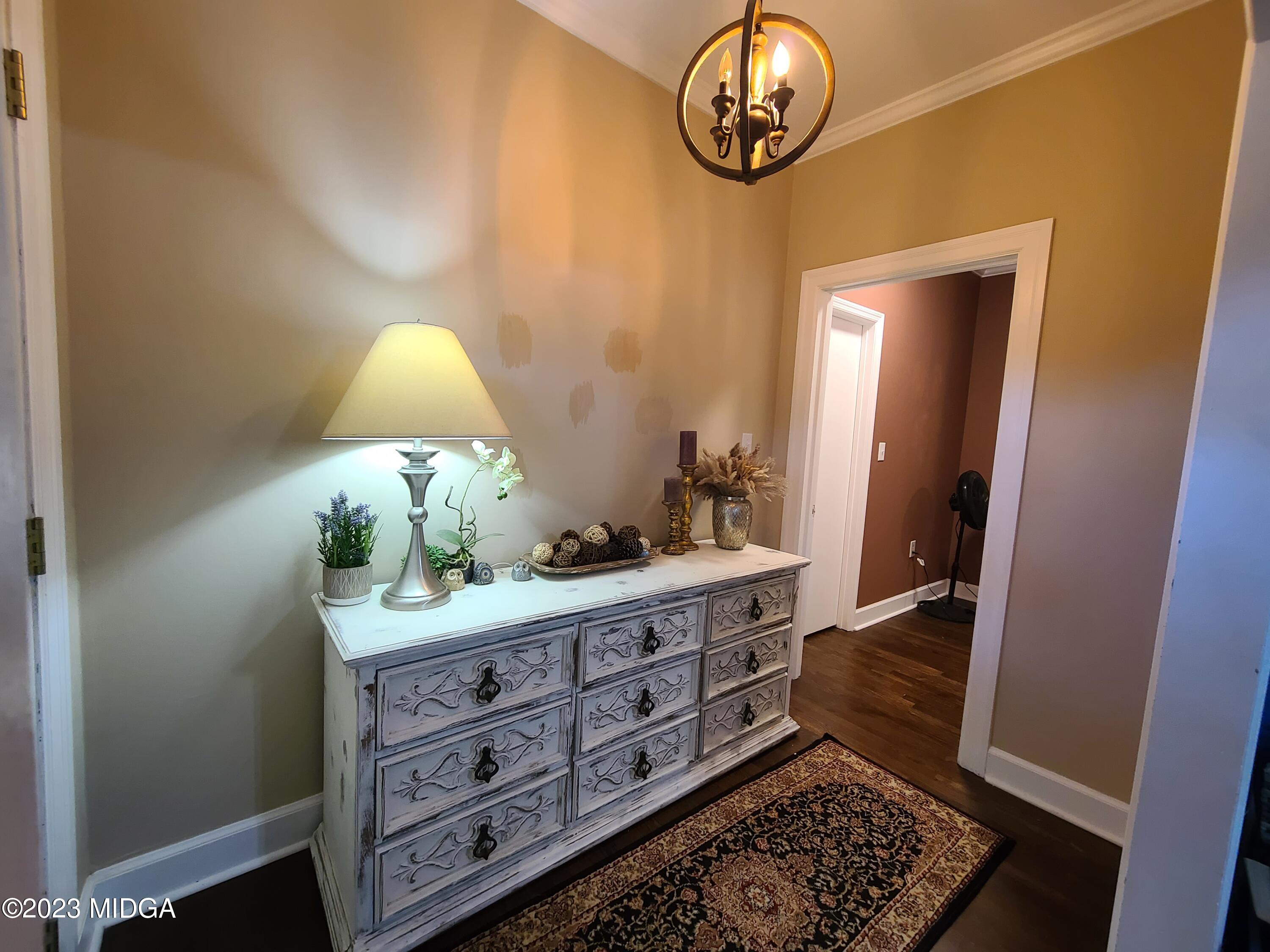 2638 Riverview Road Macon, GA 31204 - Photo 17 of 24 a room with a baby crib and a chair