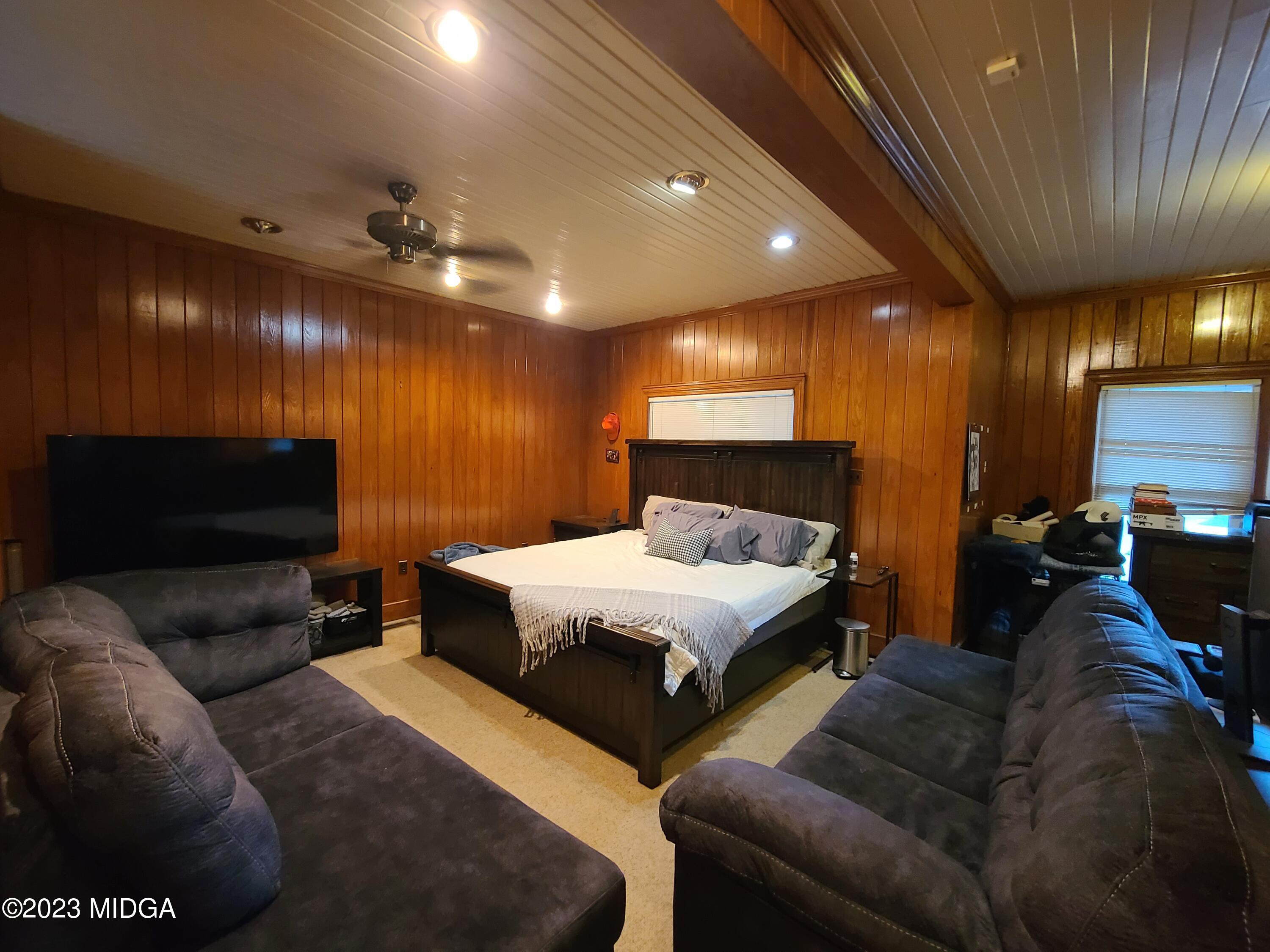 2638 Riverview Road Macon, GA 31204 - Photo 19 of 24 a bed room with furniture and a flat screen tv