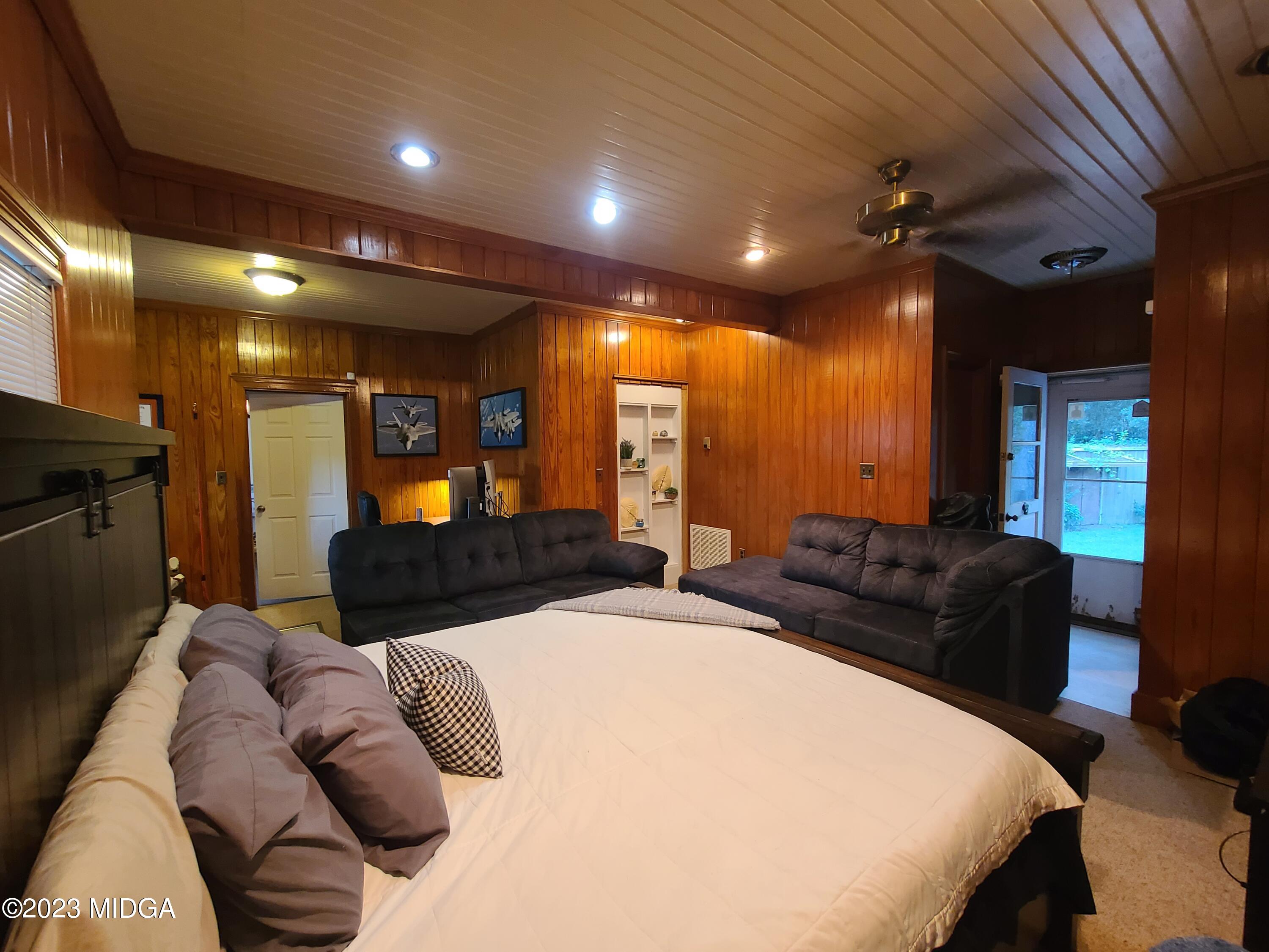 2638 Riverview Road Macon, GA 31204 - Photo 20 of 24 a large bedroom with a bed and wooden floor