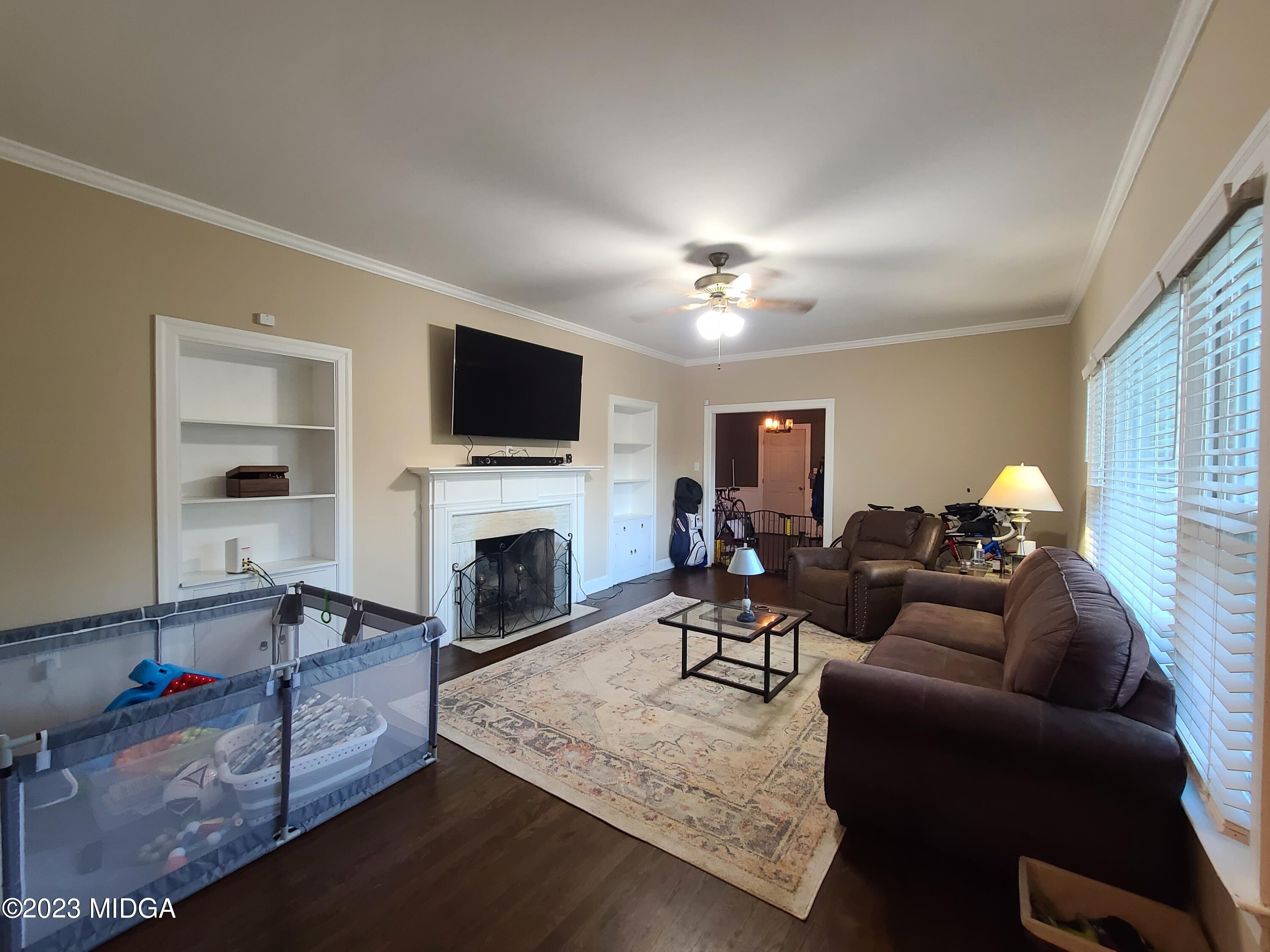 2638 Riverview Road Macon, GA 31204 - Photo 3 of 24 a living room with furniture a fireplace and a flat screen tv