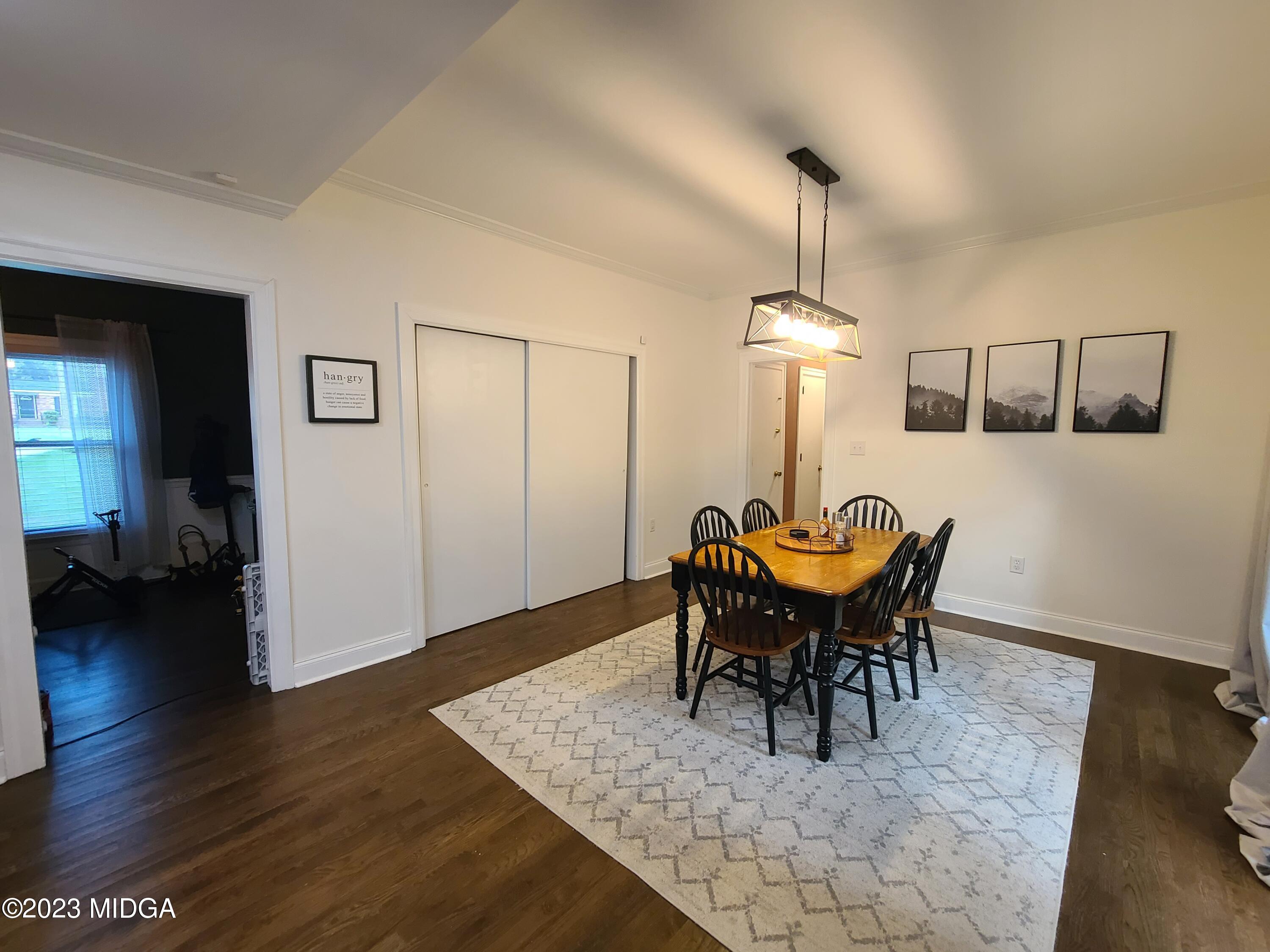 2638 Riverview Road Macon, GA 31204 - Photo 7 of 24 a dining room with furniture a chandelier and wooden floor