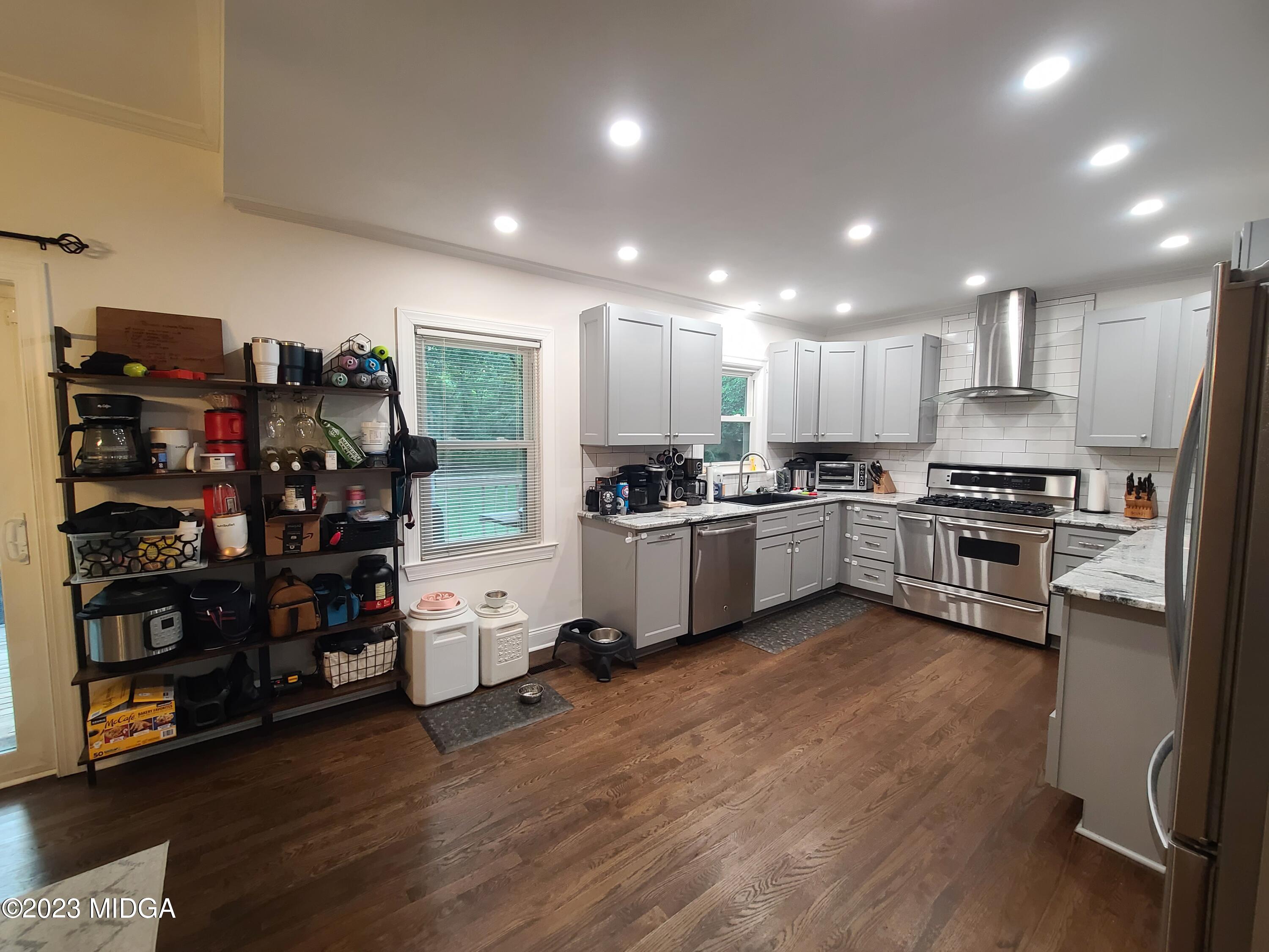 2638 Riverview Road Macon, GA 31204 - Photo 8 of 24 a kitchen with stainless steel appliances granite countertop a refrigerator sink and cabinets