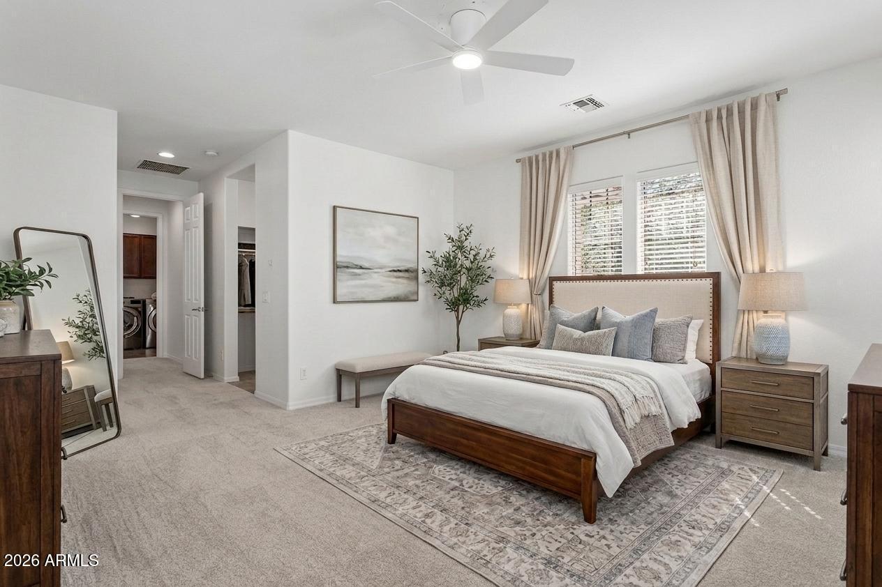 922 South Agnes Lane Gilbert, AZ 85296 - Photo 17 of 43 a bedroom with a large bed and a chandelier