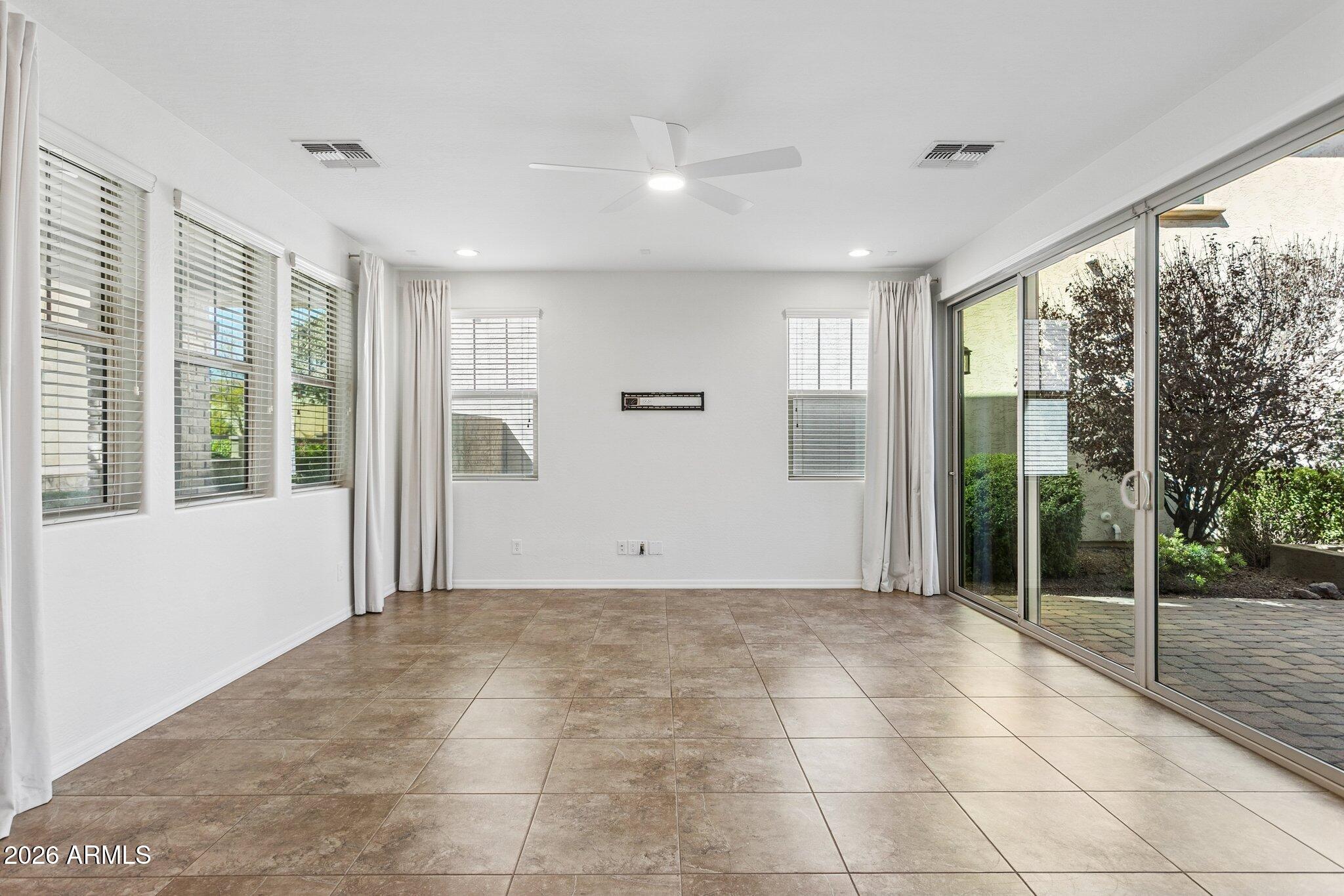 922 South Agnes Lane Gilbert, AZ 85296 - Photo 4 of 43 a view of an empty room with wooden floor and a window