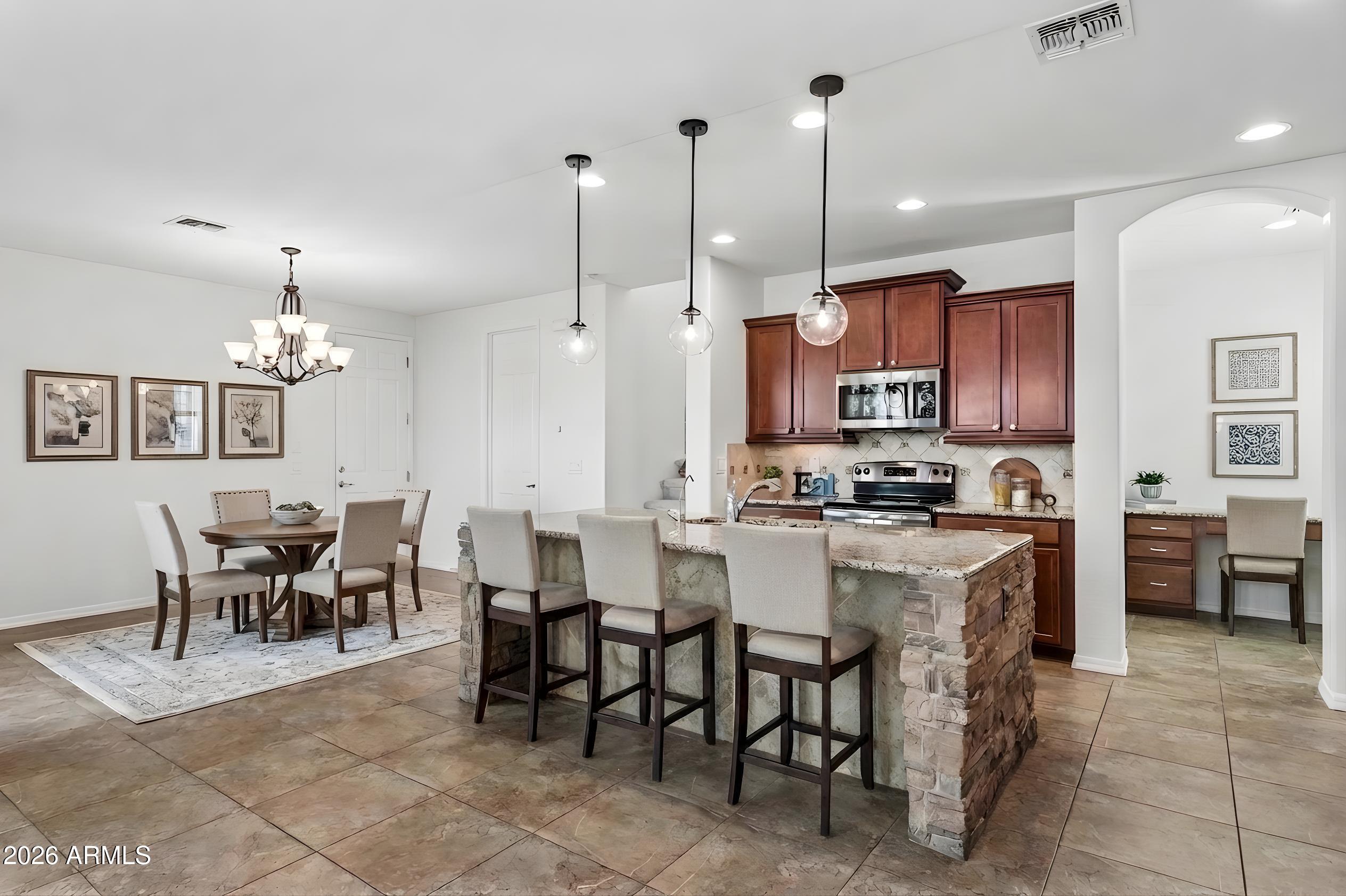 922 South Agnes Lane Gilbert, AZ 85296 - Photo 7 of 43 a large kitchen with a table and chairs