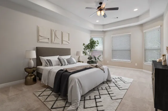 a spacious bedroom with a bed and a window