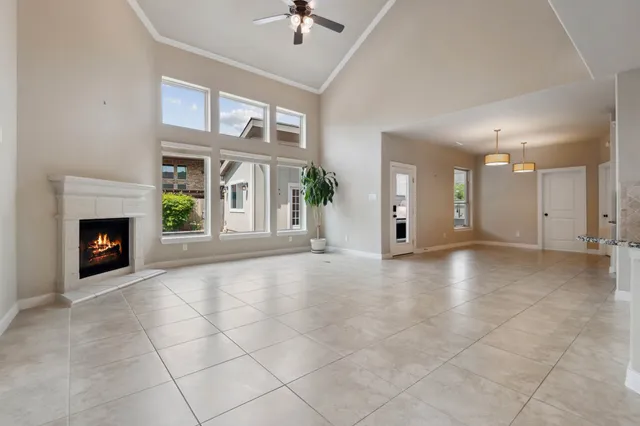a view of an empty room with a fireplace and a window