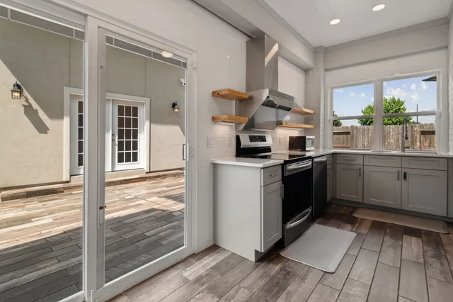 a kitchen with a sink stainless steel appliances and cabinets