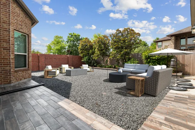 a view of a backyard with sitting area