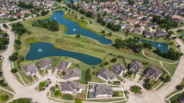 an aerial view of a house with a yard
