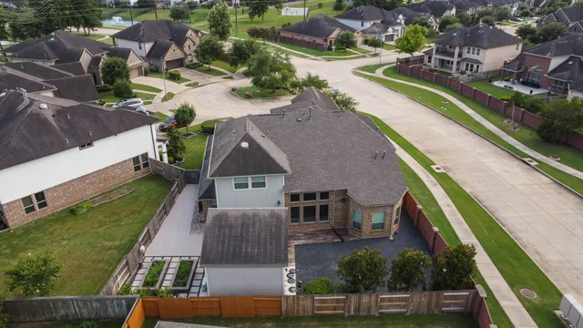 an aerial view of multiple houses with a yard