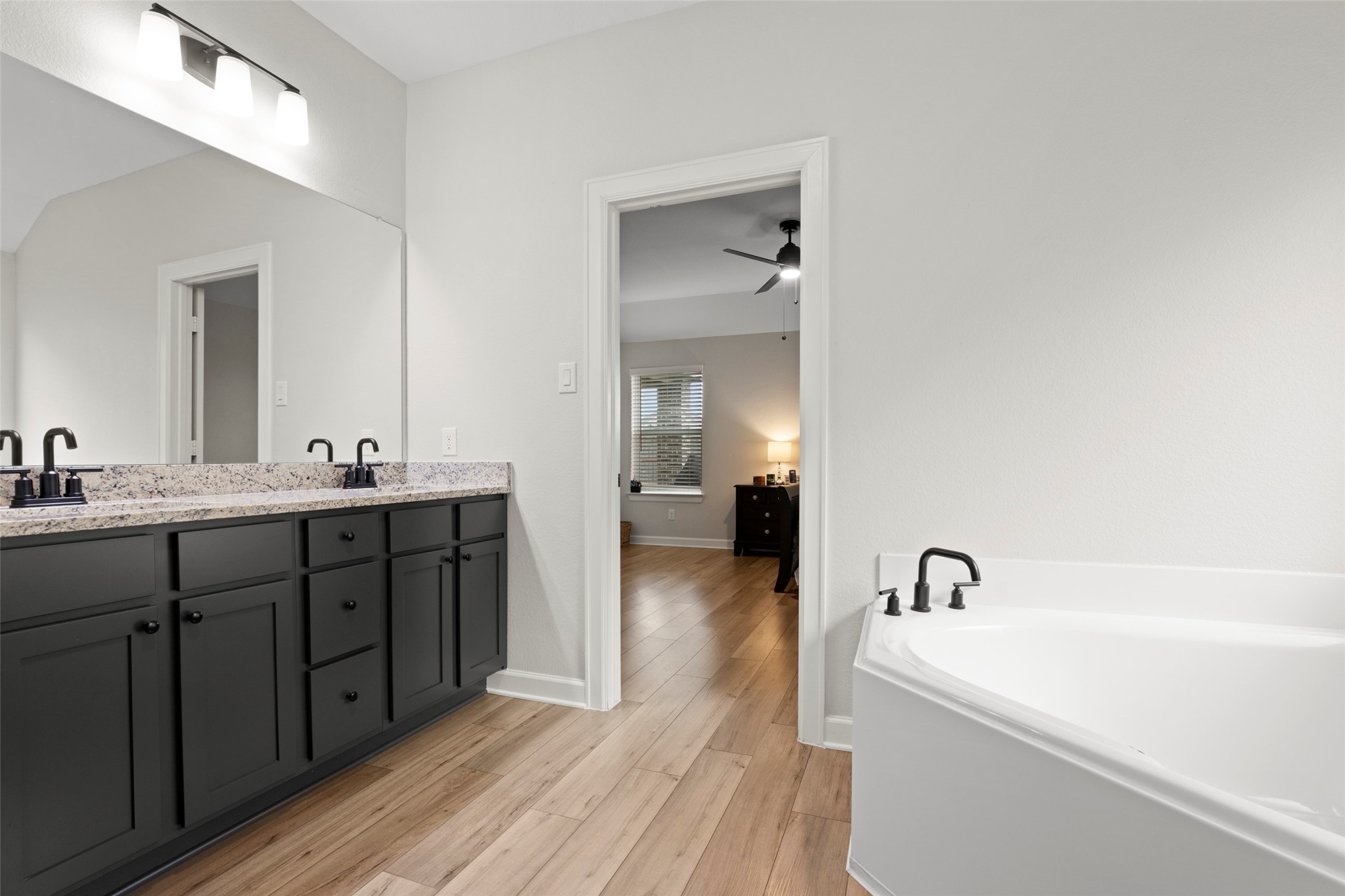 13717 Gaff Rig Drive Texas City, TX 77510 - Photo 18 of 28 a spacious bathroom with a tub sink and mirror