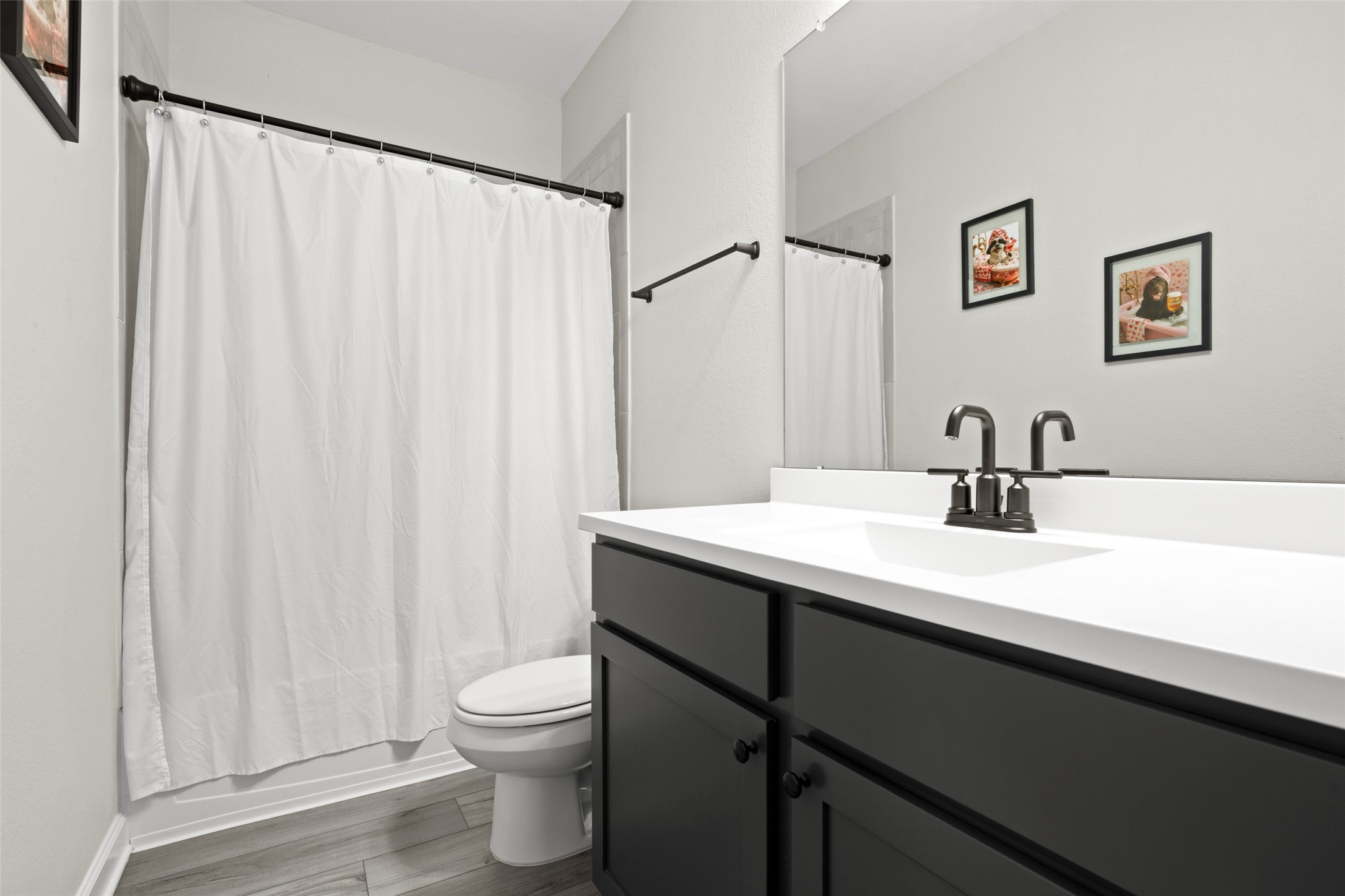 13717 Gaff Rig Drive Texas City, TX 77510 - Photo 22 of 28 a bathroom with a sink a toilet and a large mirror
