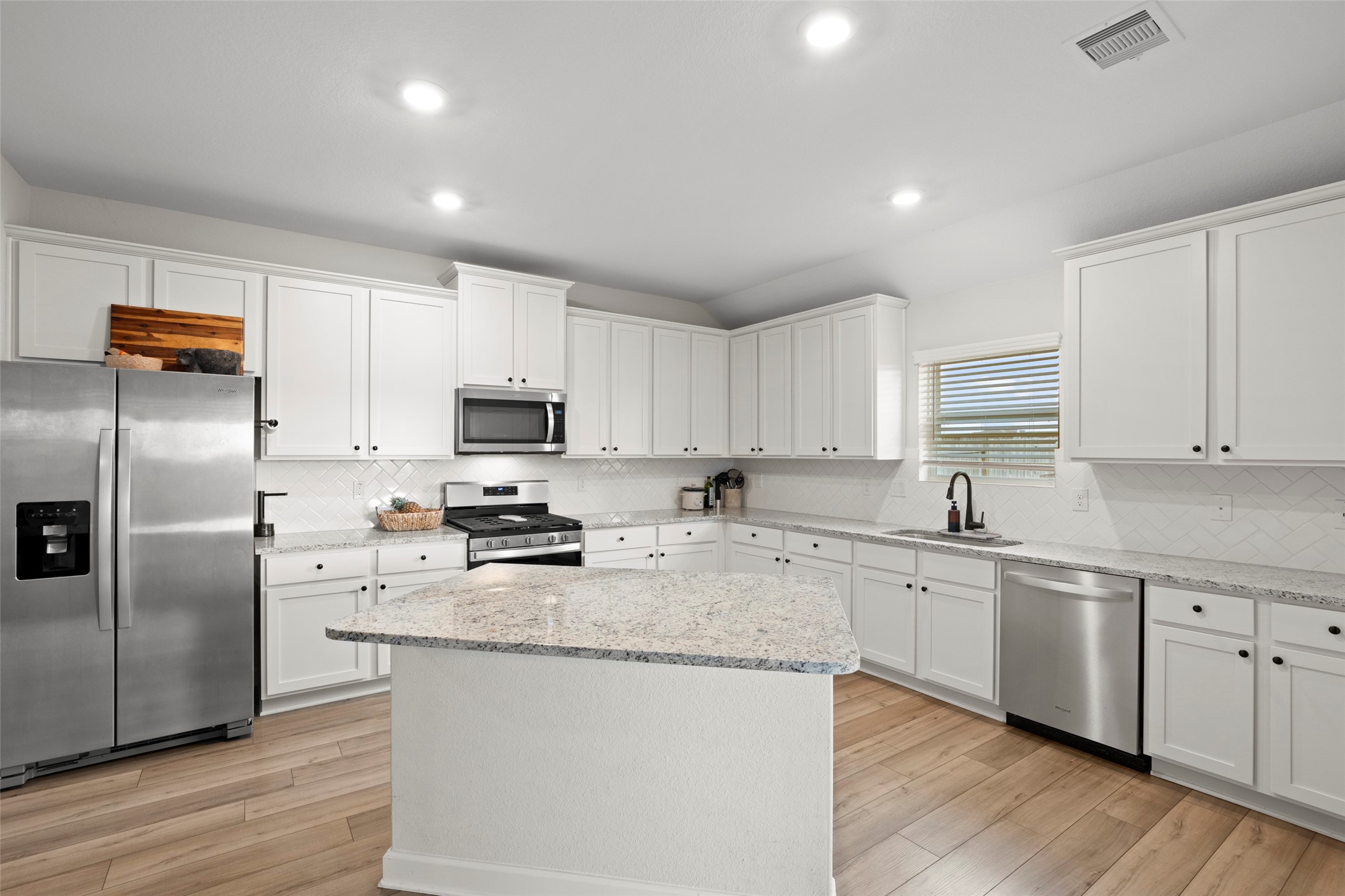13717 Gaff Rig Drive Texas City, TX 77510 - Photo 5 of 28 a kitchen with stainless steel appliances granite countertop a stove a sink a refrigerator a microwave and cabinets