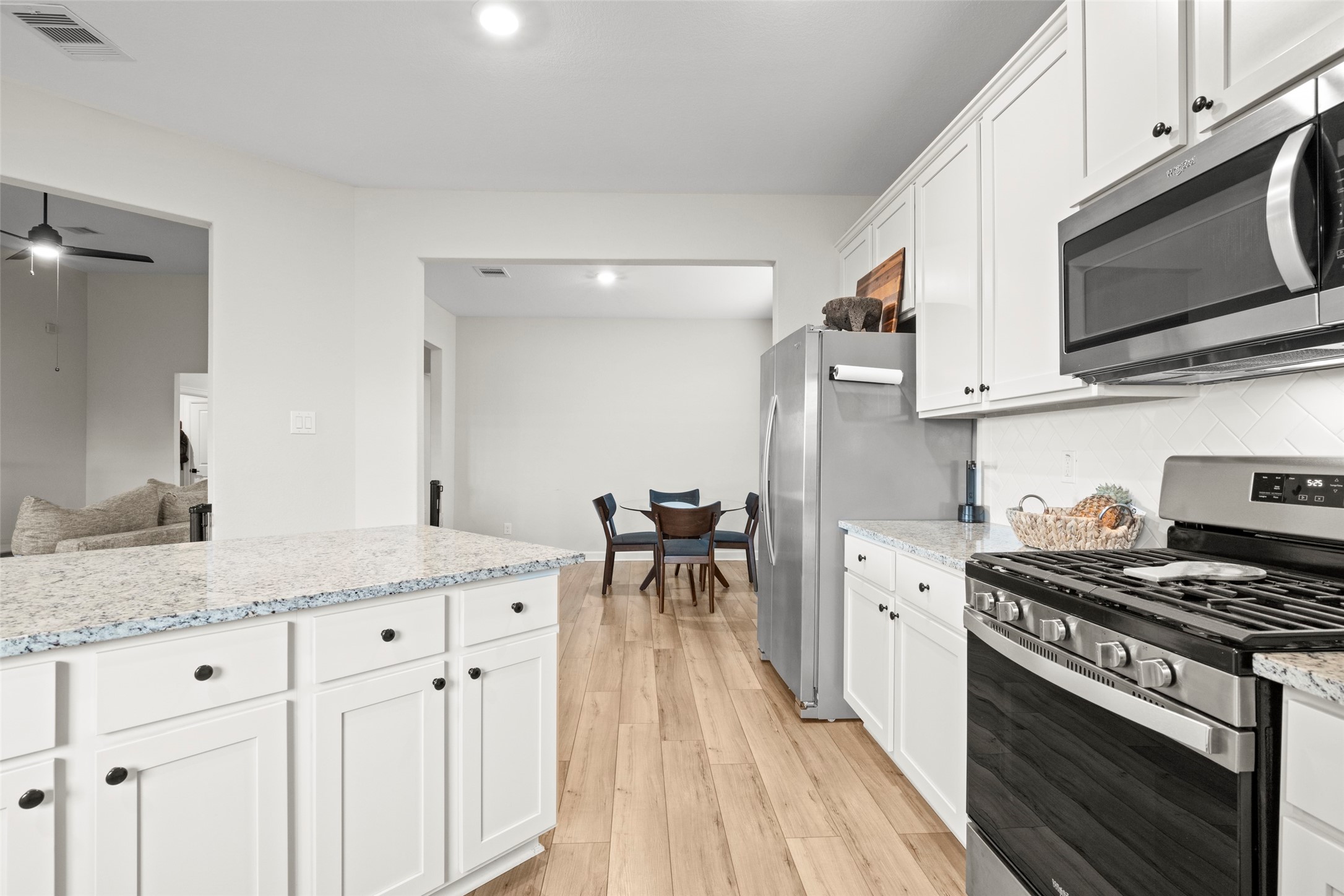 13717 Gaff Rig Drive Texas City, TX 77510 - Photo 8 of 28 a kitchen with stainless steel appliances kitchen island granite countertop a stove a sink and a microwave