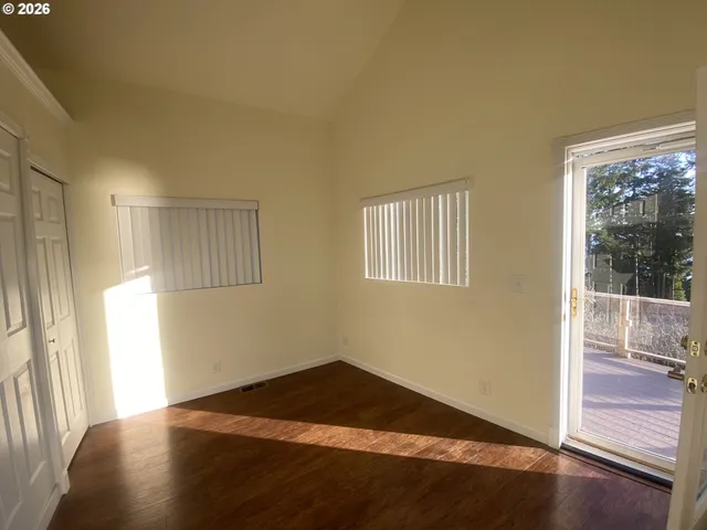 a view of a livingroom with wooden floor and a window