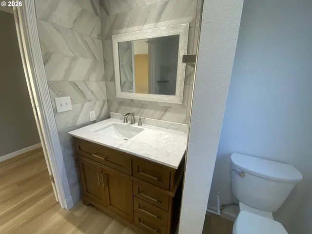 a bathroom with a sink toilet and mirror