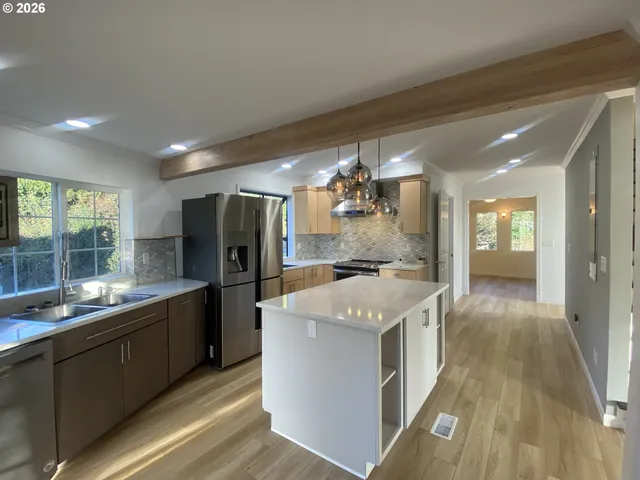a kitchen with a sink and refrigerator