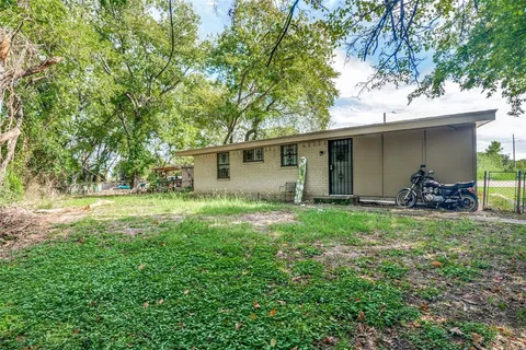 a view of backyard of house with green space