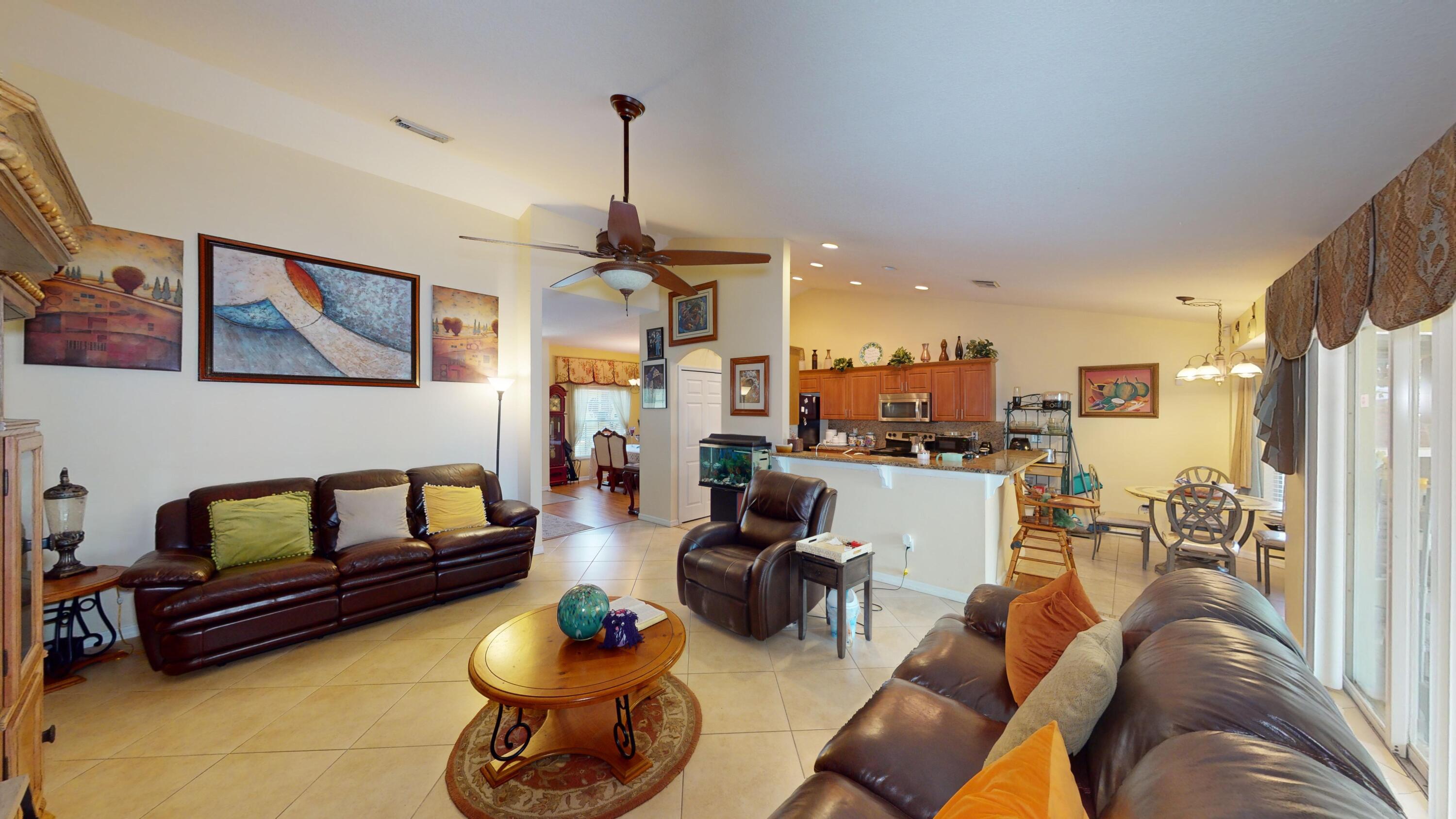 744 Southwest Monsoon Road Port St. Lucie, FL 34953 - Photo 3 of 12 a living room with furniture and a chandelier