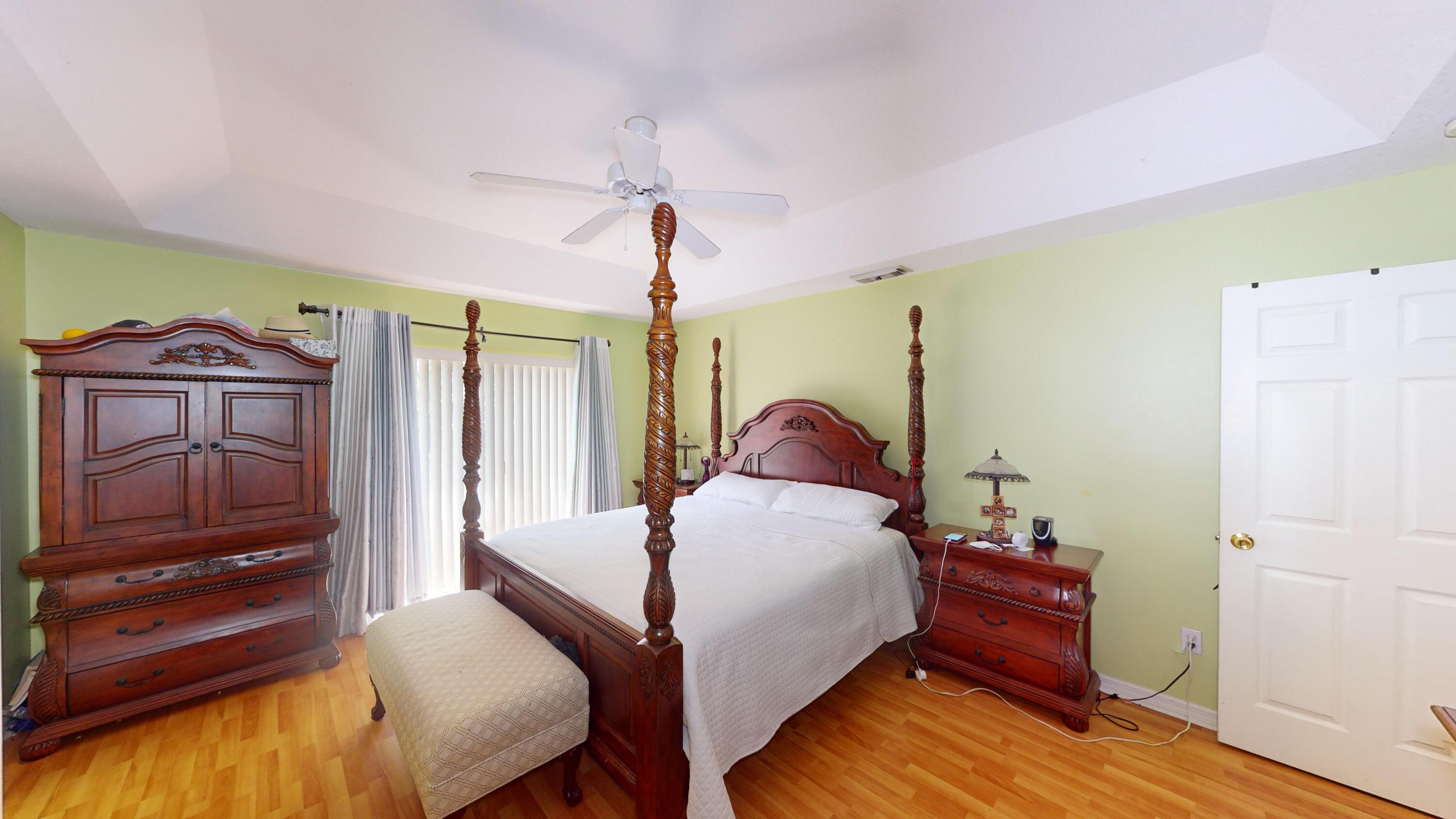 744 Southwest Monsoon Road Port St. Lucie, FL 34953 - Photo 8 of 12 a bed room with a bed and a dresser