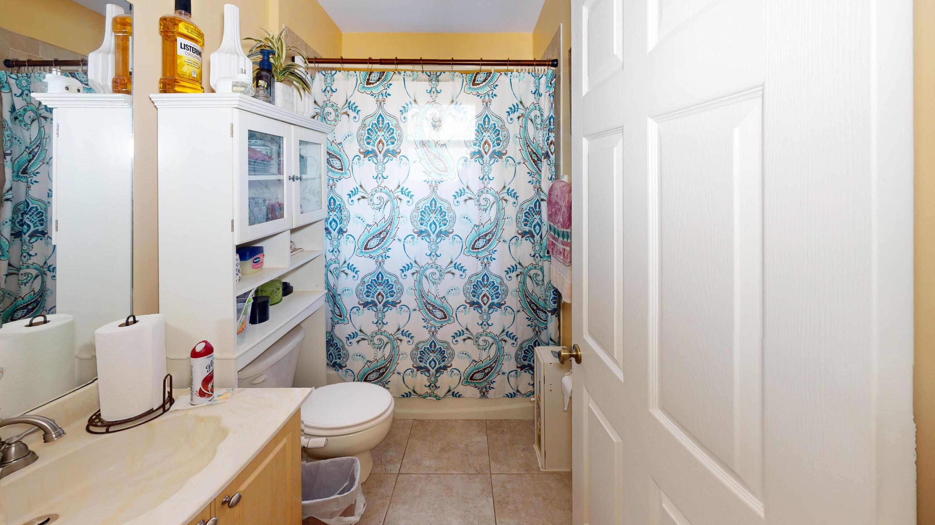 744 Southwest Monsoon Road Port St. Lucie, FL 34953 - Photo 9 of 12 a bathroom with a toilet and shower curtain