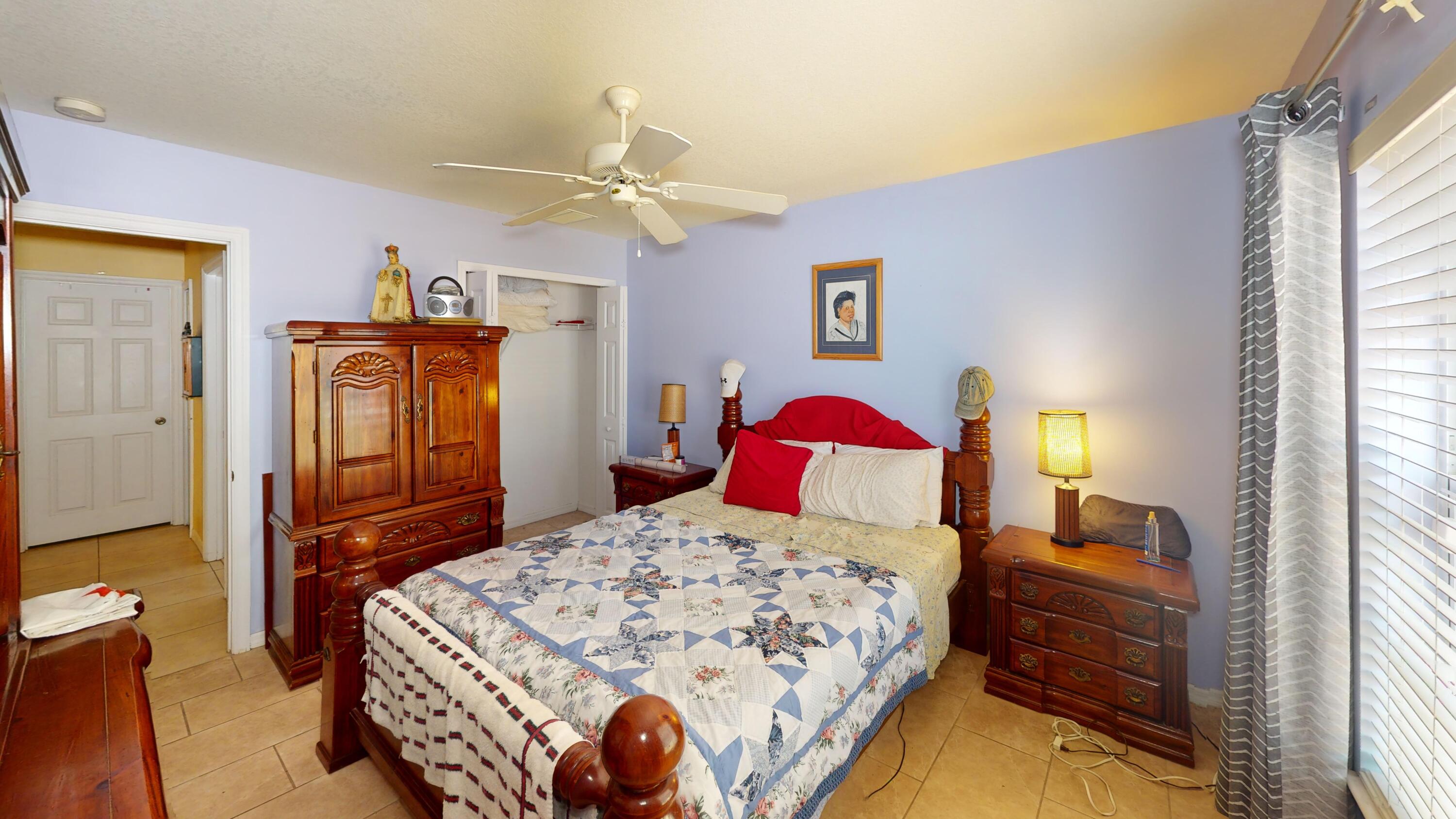 744 Southwest Monsoon Road Port St. Lucie, FL 34953 - Photo 10 of 12 a bedroom with a bed and a dresser with mirror