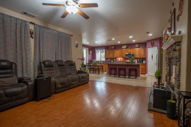 a living room with furniture and a wooden floor