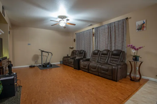 a living room with furniture a chandelier and a window