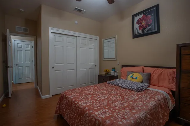 a bedroom with a bed and a painting on the wall