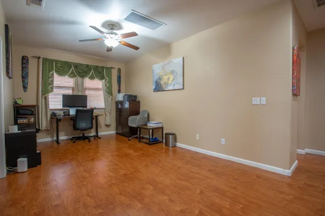 a view of a livingroom with workspace and a window