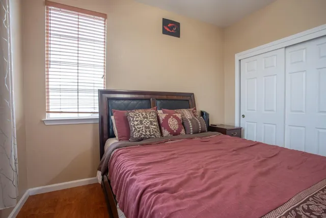 a bedroom with a bed and a window