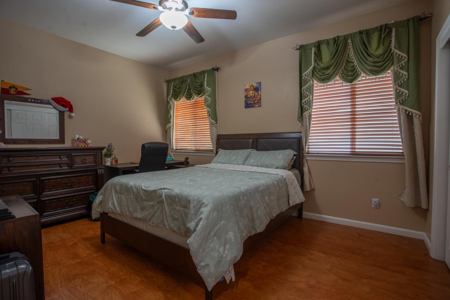 11740 Mani Circle Rancho Cordova, CA 95742 - Photo 37 of 50 a bedroom with a bed and dresser with wooden floor