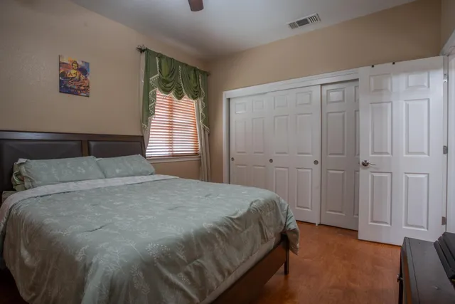 a bedroom with a bed and a window