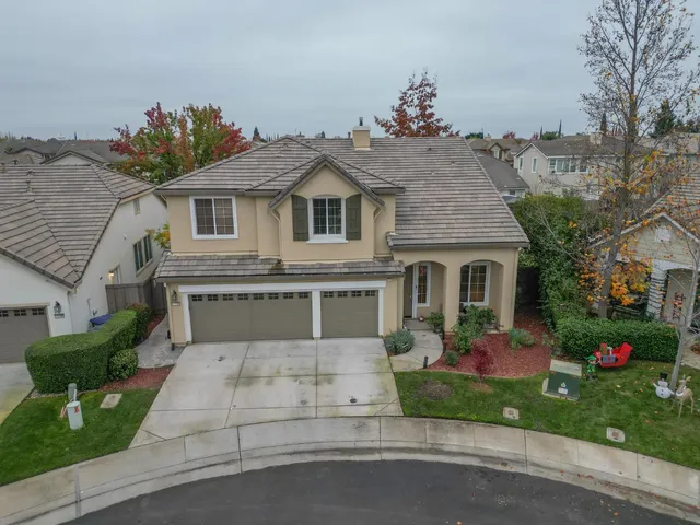 a front view of a house with a yard and a garage