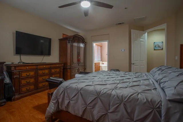 a bedroom with a bed and a flat screen tv